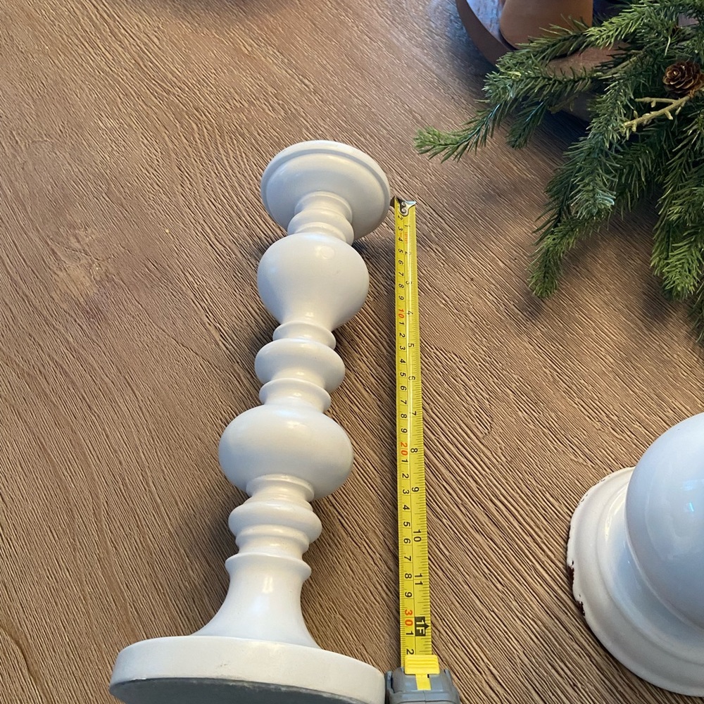 White candlestick holder. heavy material, not sure what that material is.